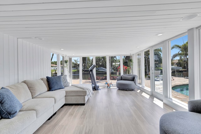 sunroom / solarium featuring a healthy amount of sunlight and french doors