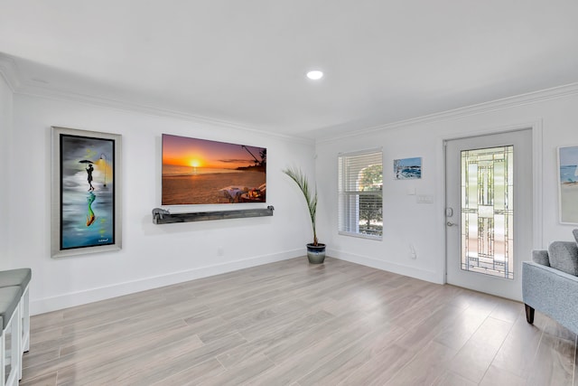 foyer with light hardwood / wood-style floors and ornamental molding