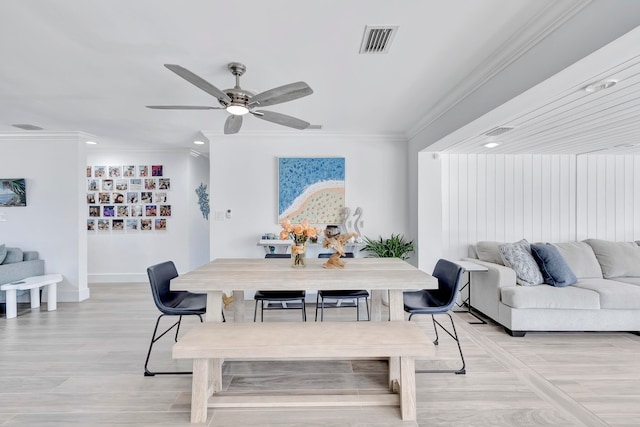 dining area featuring ceiling fan, light wood-type flooring, and ornamental molding