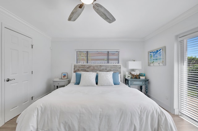 bedroom featuring ornamental molding, ceiling fan, and light hardwood / wood-style flooring