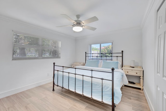 bedroom with crown molding, light hardwood / wood-style floors, and ceiling fan