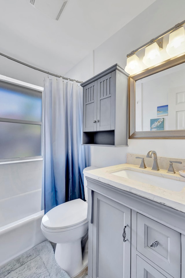 full bathroom featuring tile floors, toilet, oversized vanity, and shower / bath combo