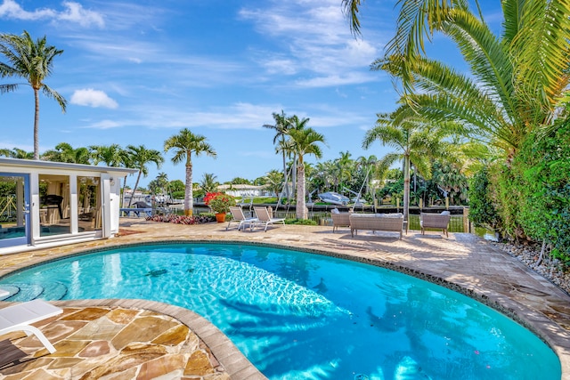 view of swimming pool with a patio area