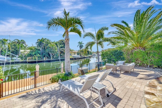 view of terrace featuring a boat dock and a water view