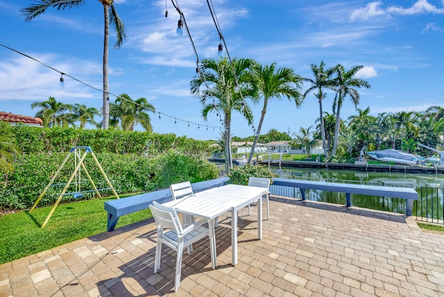 view of terrace featuring a boat dock and a water view