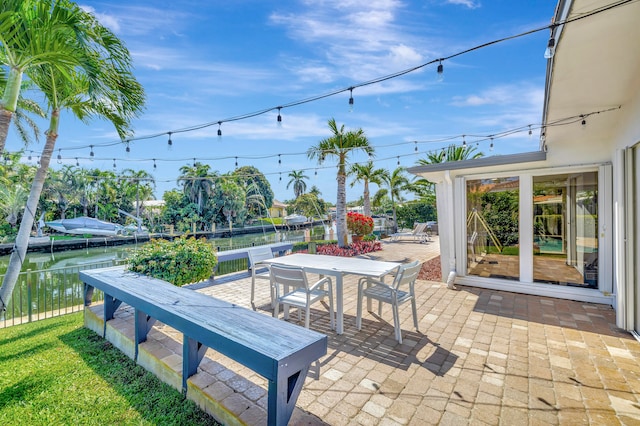 view of patio / terrace featuring a boat dock and a water view