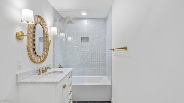 bathroom with tile flooring, tiled shower / bath combo, and vanity