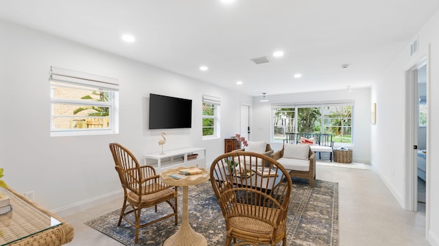 tiled living room with plenty of natural light