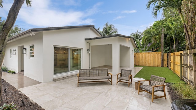 rear view of house with an outdoor hangout area and a patio