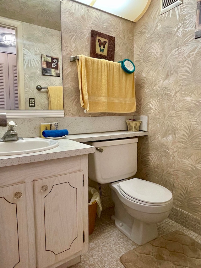 bathroom with vanity, tile floors, and toilet