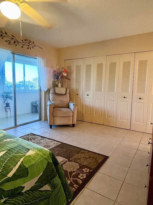 bedroom featuring light tile floors, ceiling fan, and access to outside