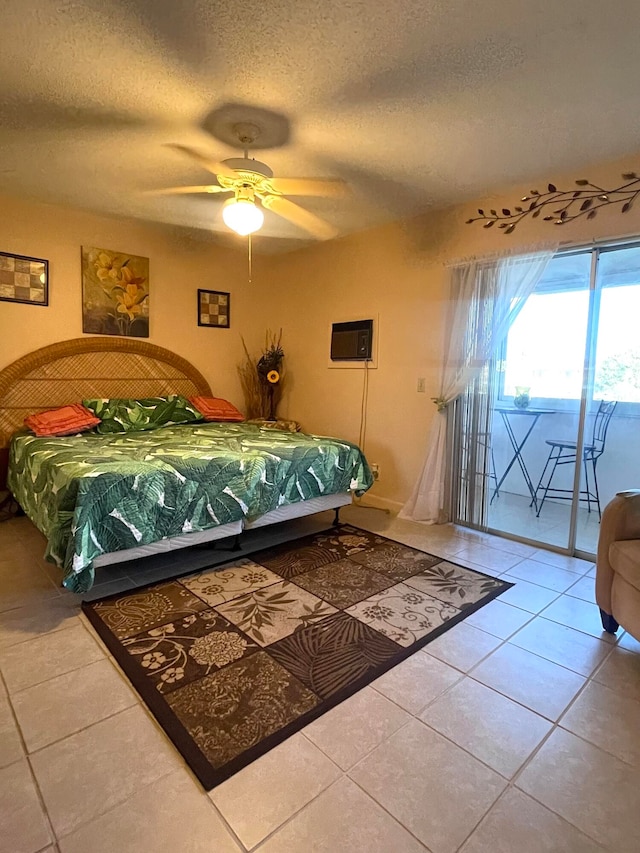 tiled bedroom with ceiling fan and a textured ceiling