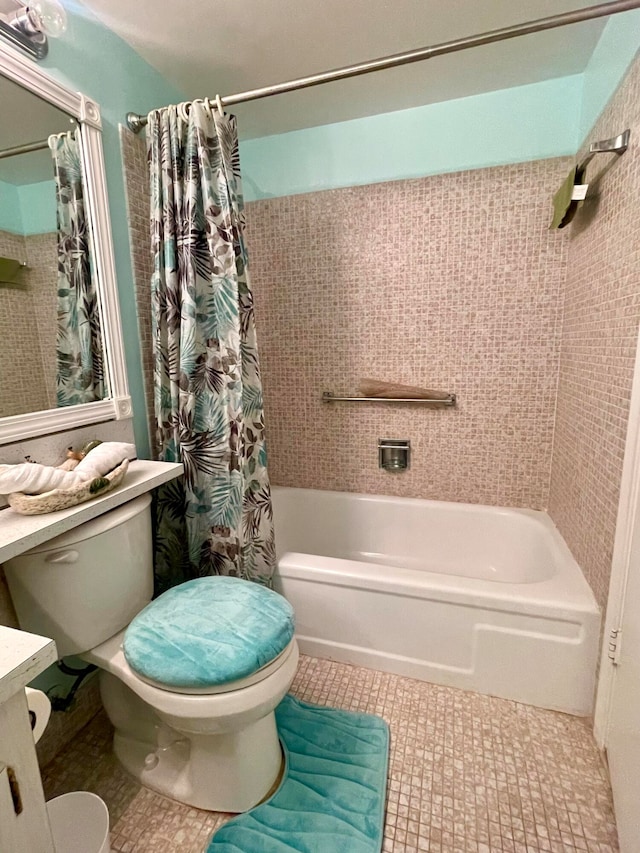 full bathroom featuring shower / bath combo with shower curtain, toilet, tile flooring, and vanity