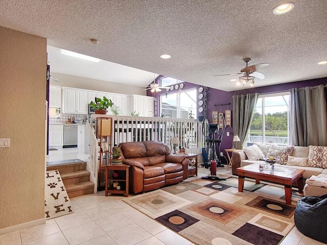 tiled living room with ceiling fan and a textured ceiling