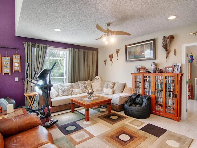 tiled living room featuring a textured ceiling and ceiling fan