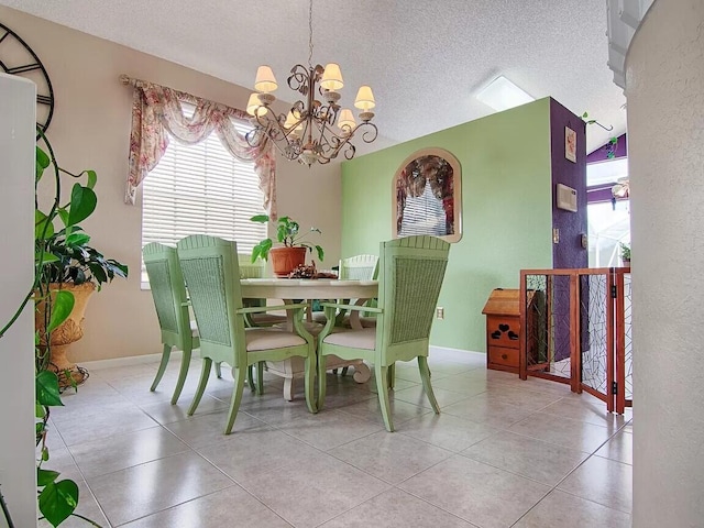 dining area with lofted ceiling, light tile floors, a textured ceiling, and an inviting chandelier