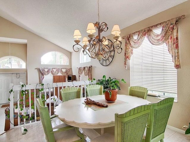 tiled dining room featuring a notable chandelier, lofted ceiling, and a textured ceiling