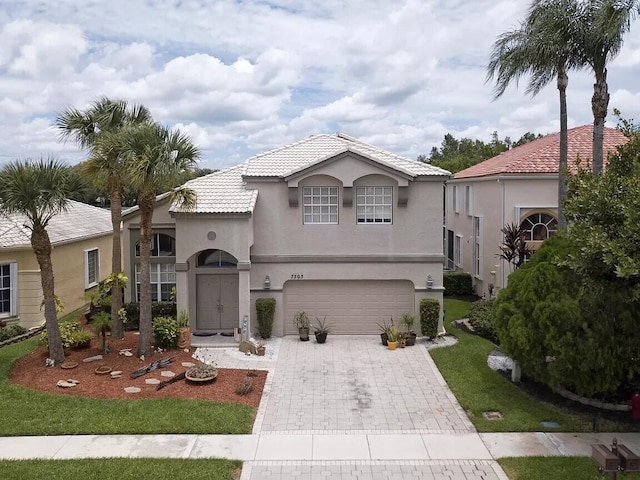 mediterranean / spanish-style home with a garage