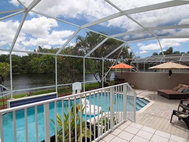 view of swimming pool with glass enclosure and a patio