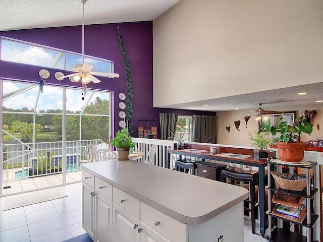 kitchen with light tile flooring, ceiling fan, and a wealth of natural light