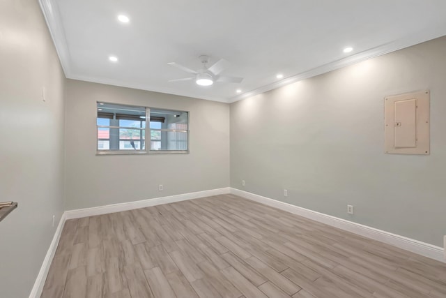 spare room featuring light hardwood / wood-style flooring, ceiling fan, and crown molding