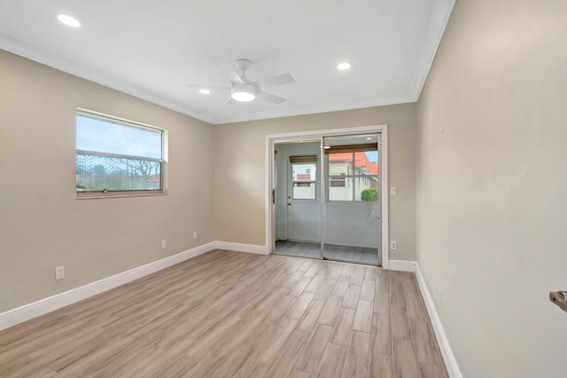 unfurnished room with ornamental molding, ceiling fan, a wealth of natural light, and light hardwood / wood-style flooring