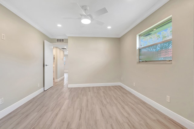 spare room featuring crown molding, light hardwood / wood-style floors, and ceiling fan