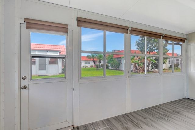 doorway to outside featuring a healthy amount of sunlight and light hardwood / wood-style floors