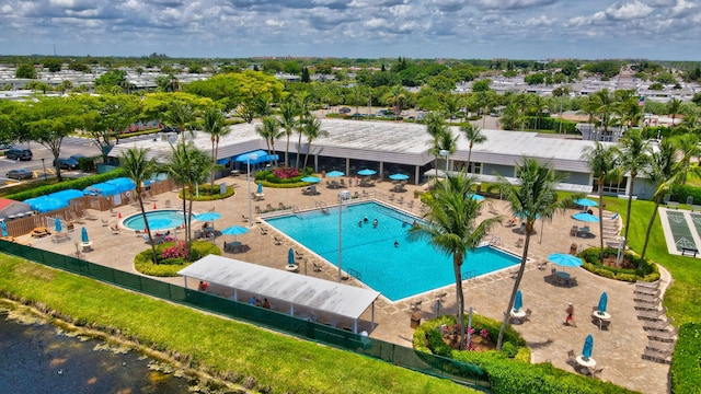 view of swimming pool with a yard and a patio