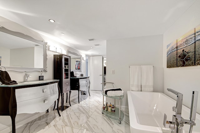 bathroom featuring vanity and a tub