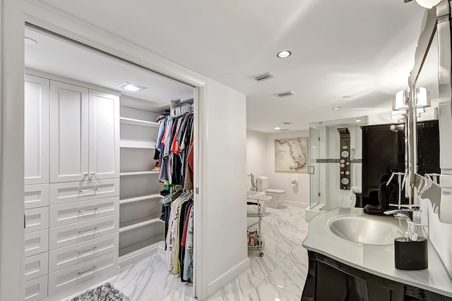 bathroom featuring an enclosed shower, vanity, and toilet