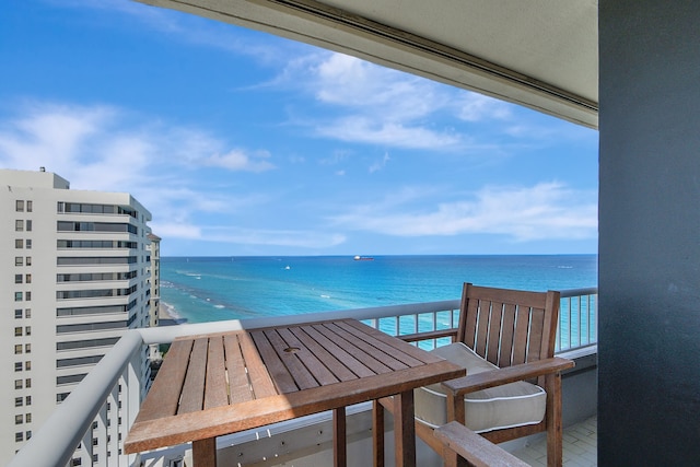 balcony featuring a water view and a view of the beach