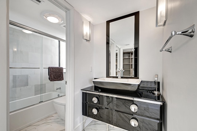 full bathroom featuring vanity, toilet, and enclosed tub / shower combo