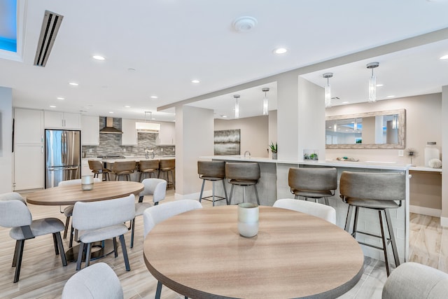 dining space featuring light wood-type flooring