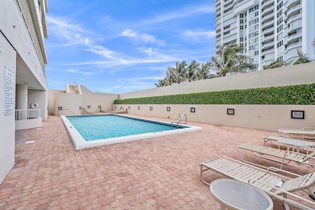 view of swimming pool with a patio area