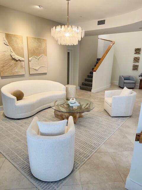 5250 N Ocean Dr Phn, Phn, Singer Island, FL 33404 - living area with stairs, a chandelier, and baseboards