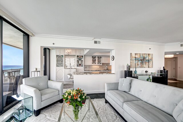 living room with a water view and crown molding