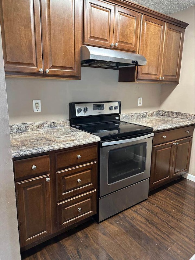 kitchen with light stone countertops, stainless steel range with electric cooktop, and dark hardwood / wood-style flooring