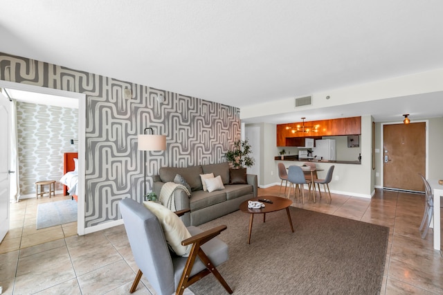 tiled living room with an inviting chandelier