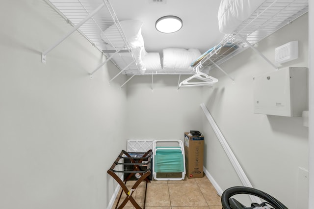 walk in closet featuring light tile floors