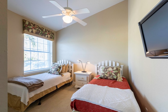 bedroom with light carpet, vaulted ceiling, and ceiling fan