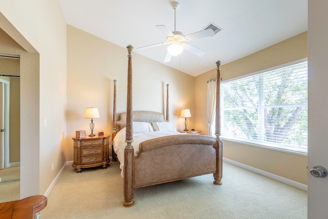 carpeted bedroom with vaulted ceiling and ceiling fan