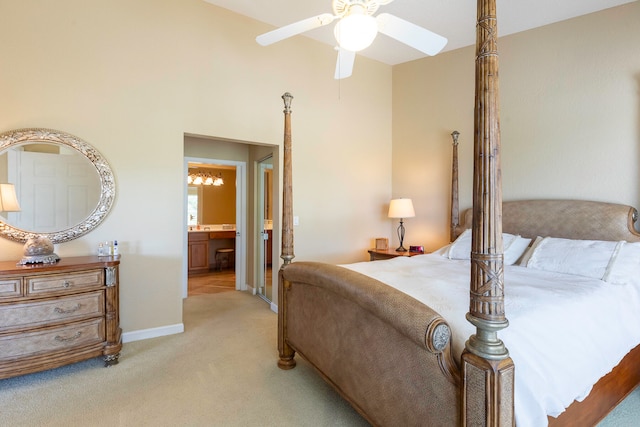 bedroom with ceiling fan, ensuite bathroom, and light colored carpet