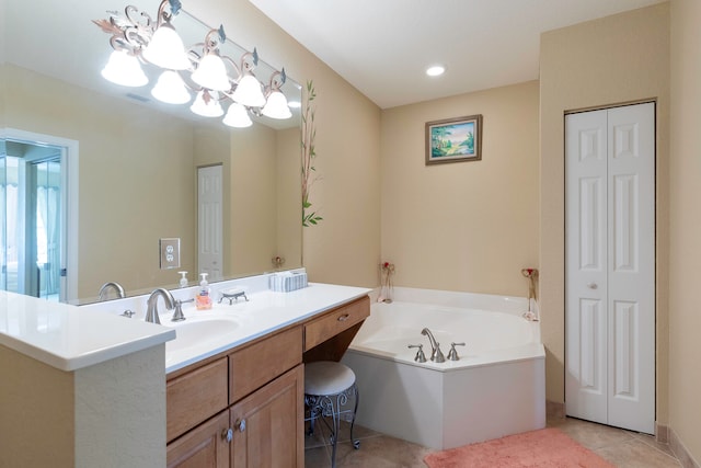 bathroom with an inviting chandelier, tile floors, vanity, and a bathtub