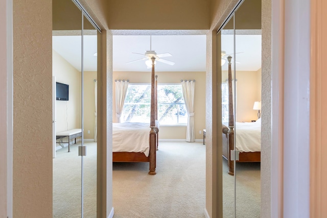 bedroom with light colored carpet and ceiling fan