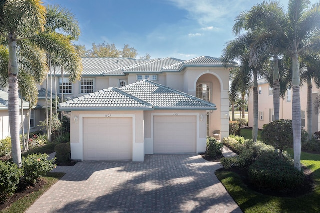 mediterranean / spanish-style house with a garage