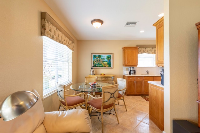 dining area with sink and light tile floors