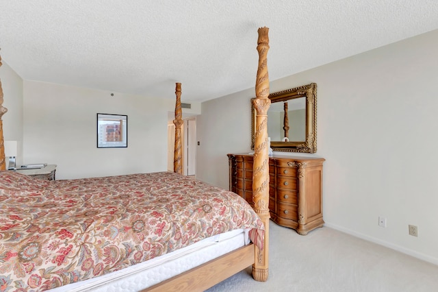 bedroom featuring a textured ceiling and light colored carpet