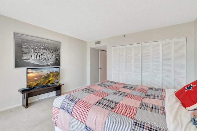 carpeted bedroom featuring a closet and a textured ceiling