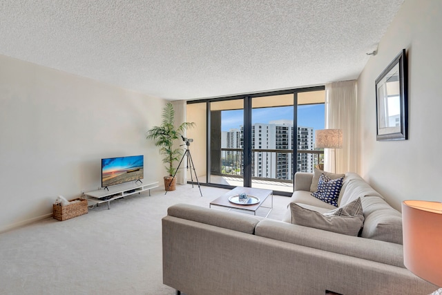 living room featuring light carpet, a textured ceiling, and a wall of windows